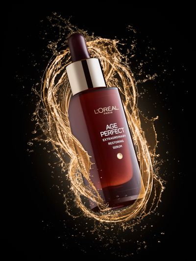 L'oreal age perfect serum surrounded by splashes. Used to demonstrate the freezing of liquid using flash duration