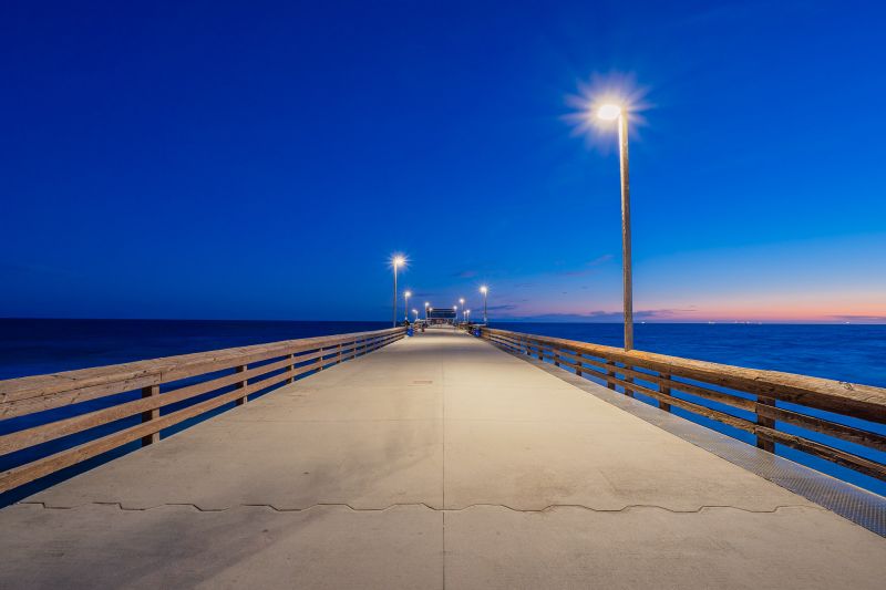 Pier at sunset with overhead lights